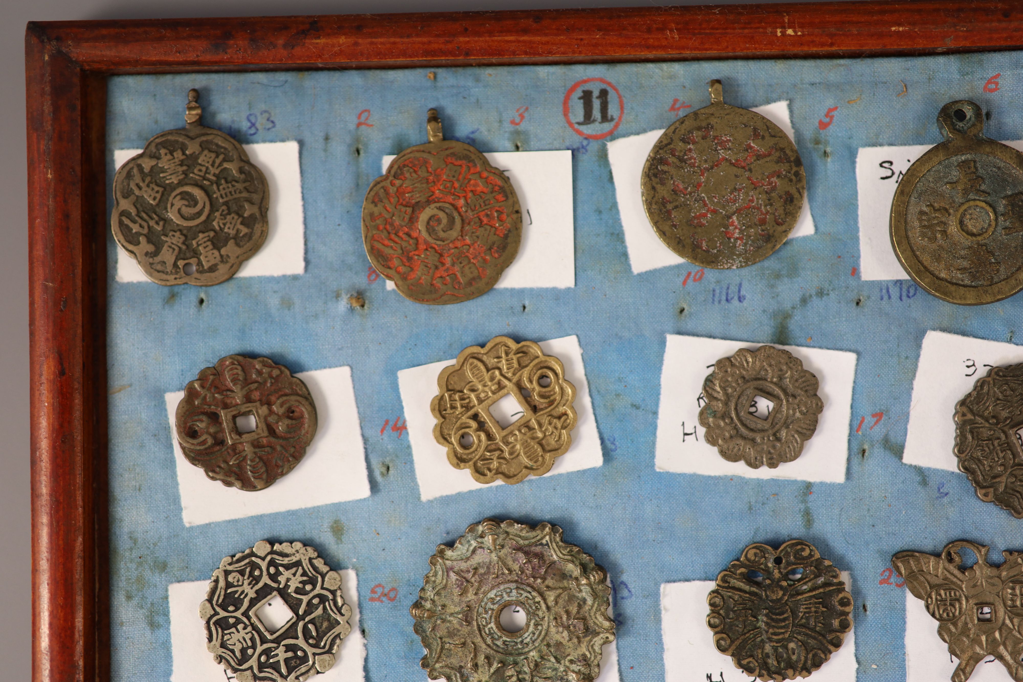 A group of 99 Korean bronze and metal amulets or charms, 19th/20th century